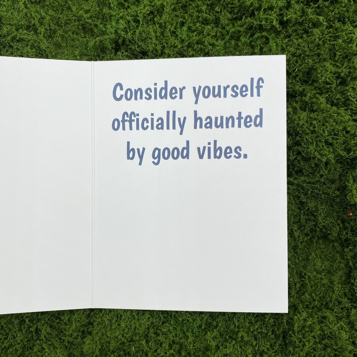 Open interior of the greeting card showing the printed message "Consider yourself officially haunted by good vibes."