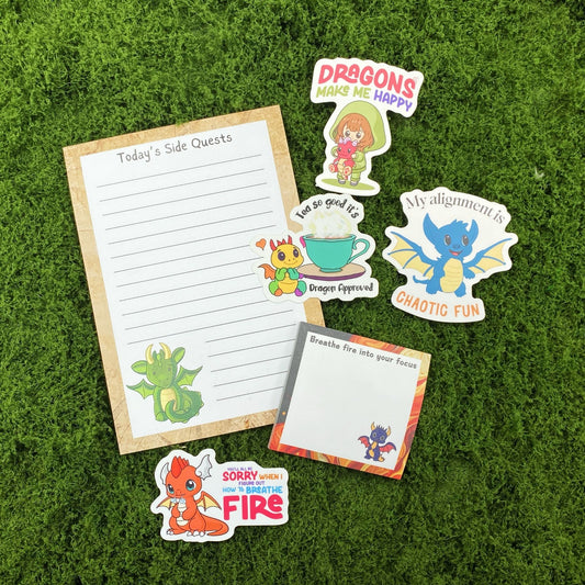 Today’s Side Quests notepad, Breathe Fire sticky notes, and four baby dragon stickers on a green moss background.
