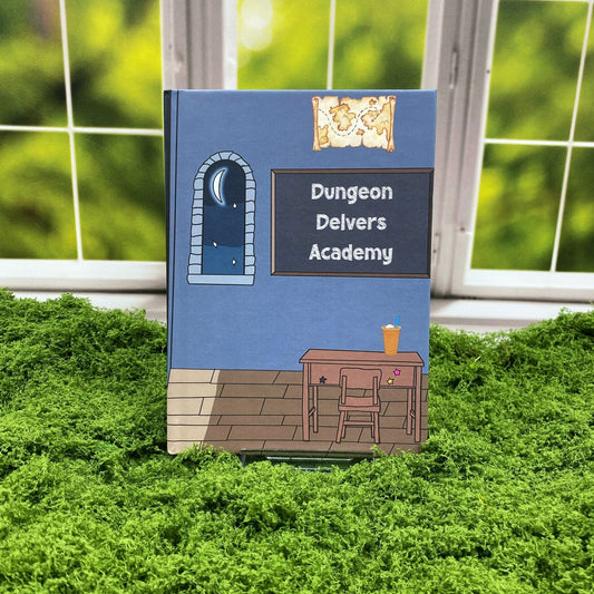 Hardcover journal illustrated with a fantasy classroom scene featuring a starlit window, a desk with an iced drink, and a chalkboard reading 'Dungeon Delvers Academy,' displayed on a moss mat with a window backdrop.
