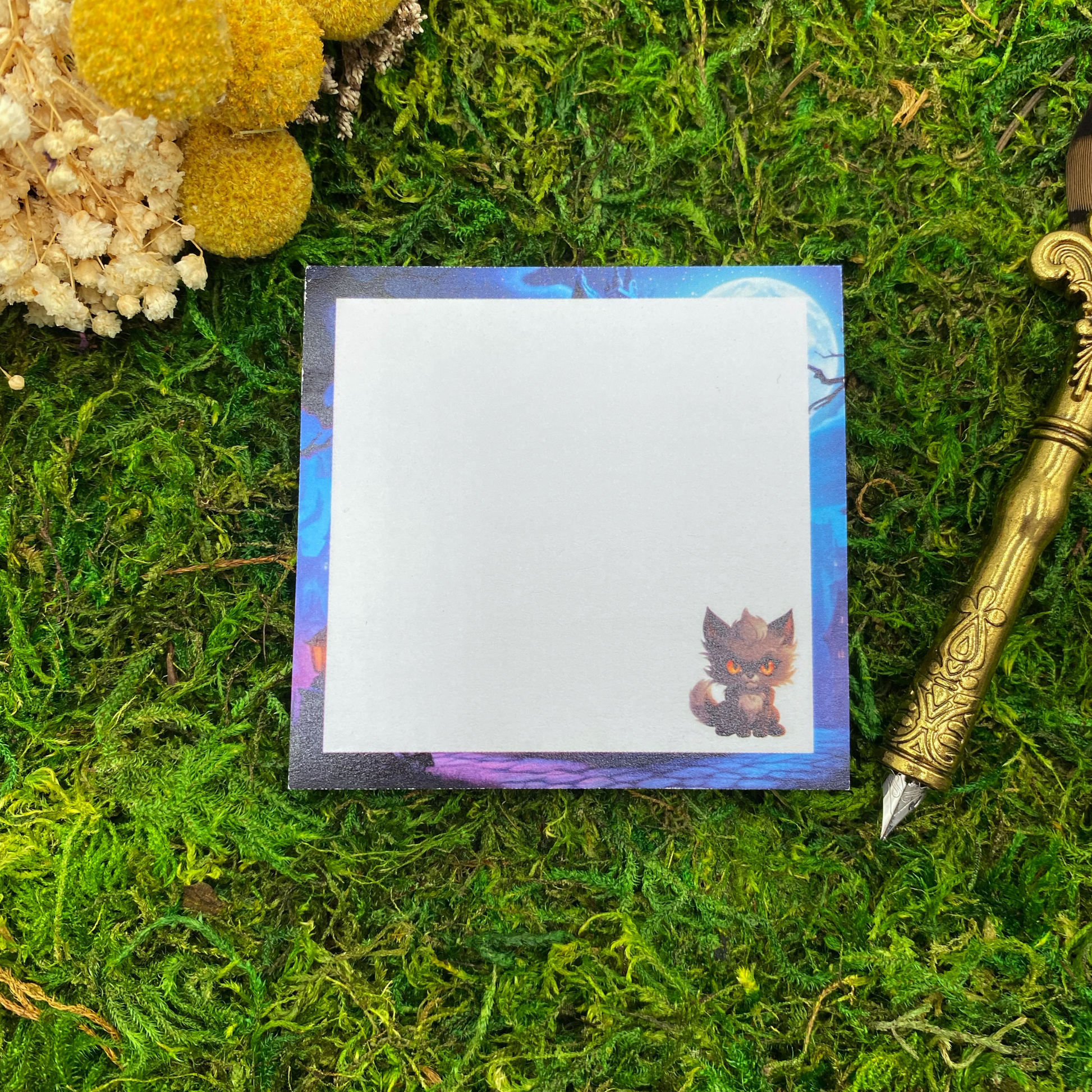 Square sticky note pad with a moonlit purple and blue forest border and a small orange-eyed werewolf cub illustration in the corner, resting on moss next to dried yellow and white flowers and a gold quill pen.